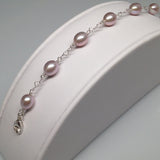 CLASSIC 7-STONE 7x8.5mm Naturally Pink Oval Freshwater Pearl Interlocking Heart Bracelet